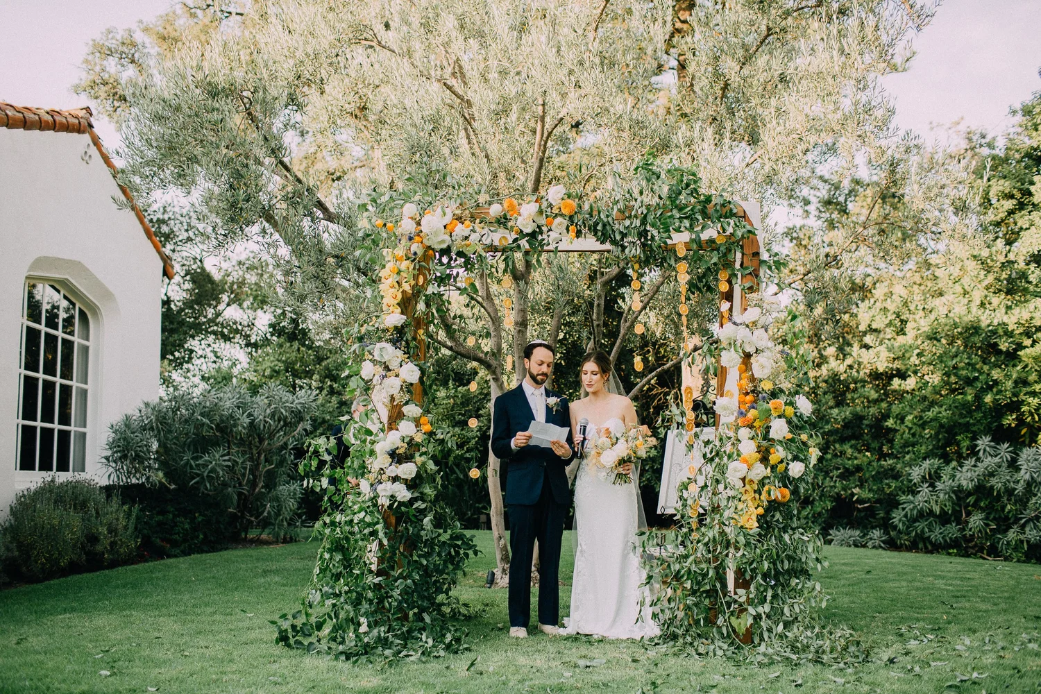 Garden ceremony floral arch under the trees