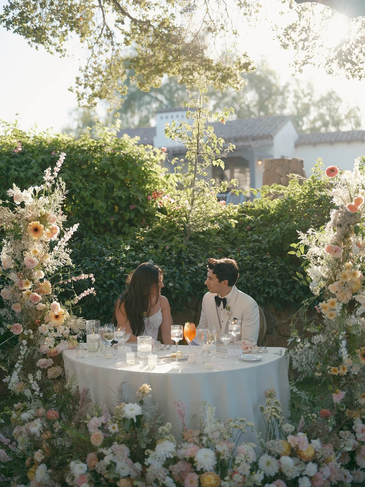 Garden sweetheart table with lush reception florals